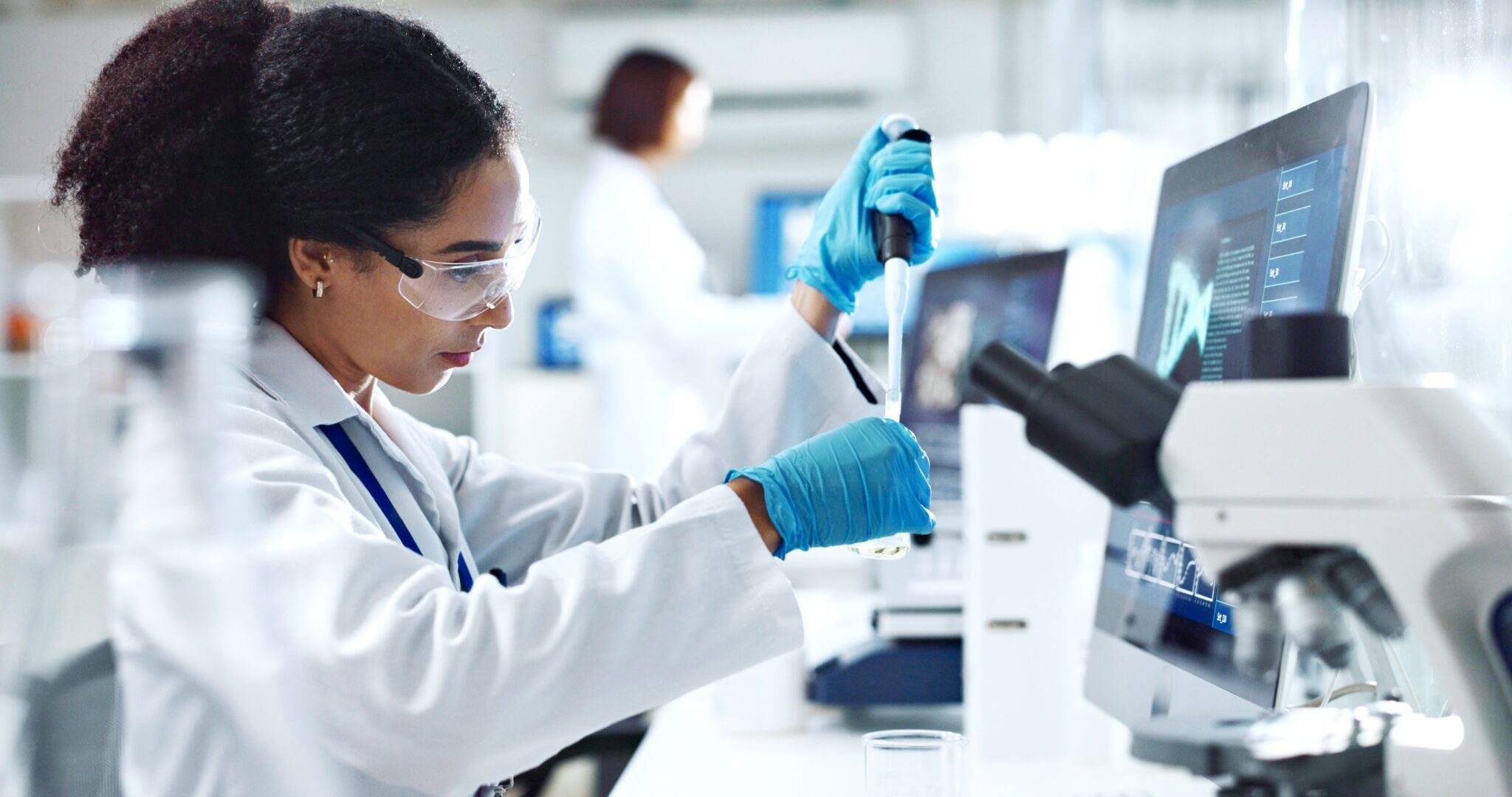 Female Scientist in Lab with pipette and microscope